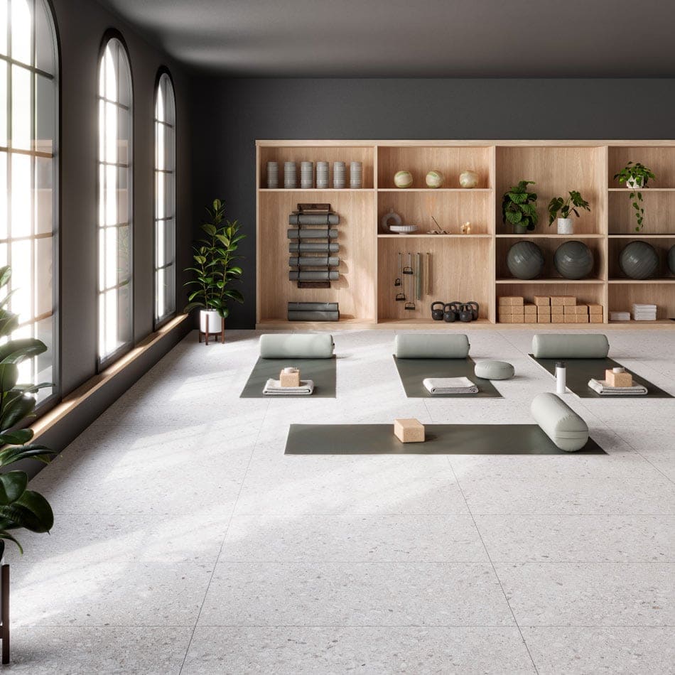 Yoga studio with terrazzo-look porcelain tile flooring featuring a soft textured surface and durable finish