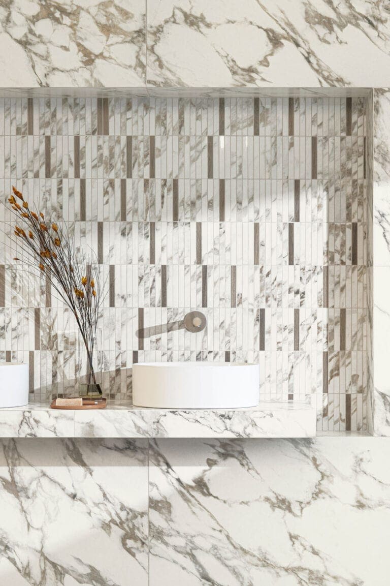 Random tile design in recessed bathroom backsplash with marble-look mosaic and wood-look accent tiles