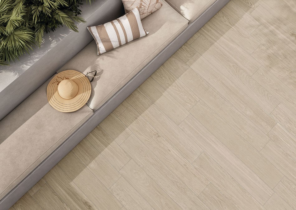 Outdoor patio featuring beachy birchwood-look porcelain tile flooring paired with a built-in bench and lush greenery
