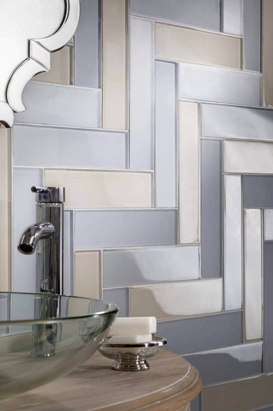 Silver and gold herringbone tile backsplash