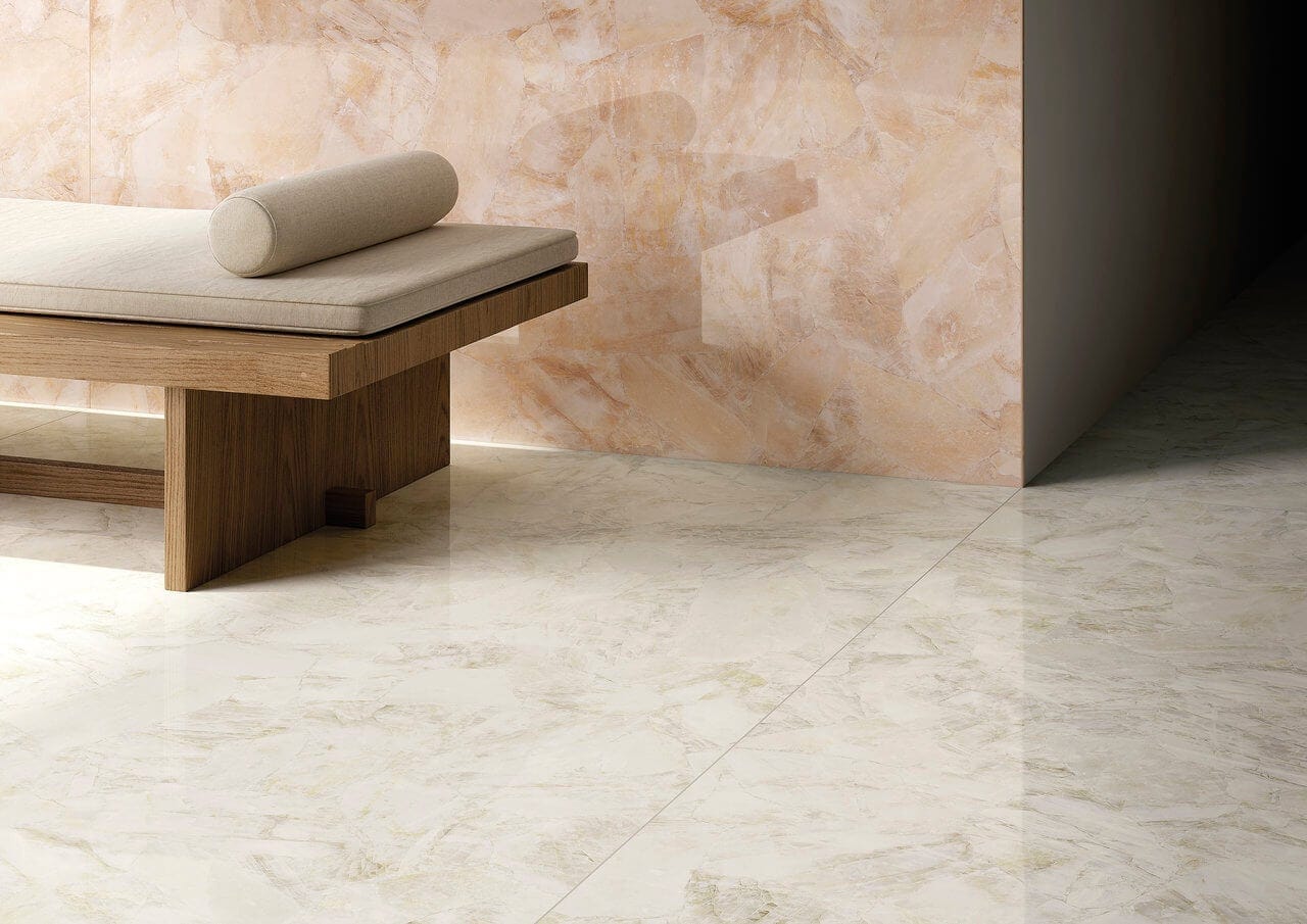 Gauged porcelain tile panels in a blush stone look combine for a soft, biophilic pairing.