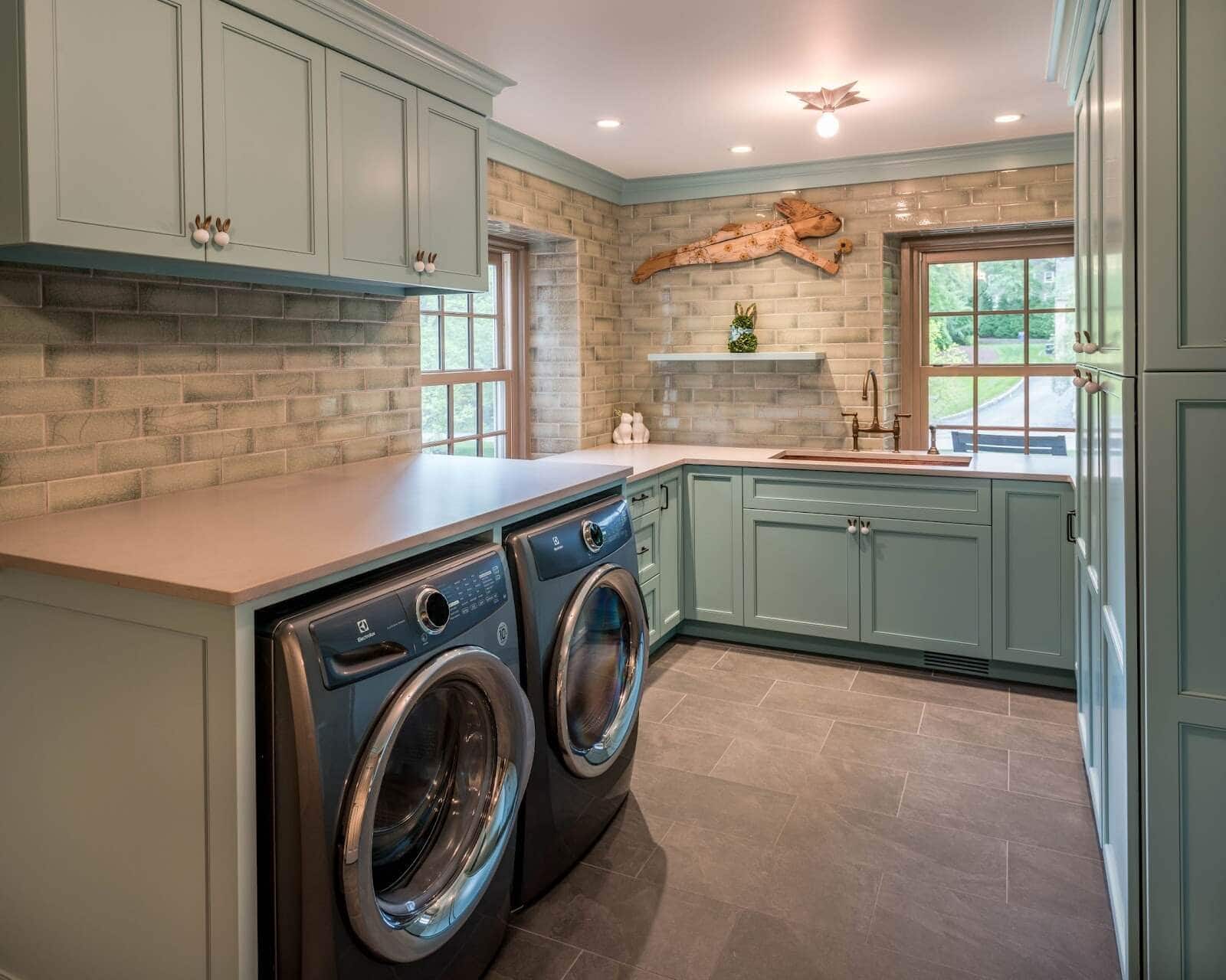 Upgraded laundry room space with ceramic tile flooring