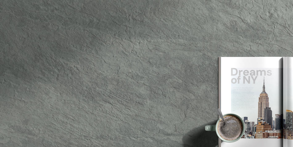 Slate-look ceramic tile with realistic surface irregularities, mimicking the natural dips and recesses of real stone